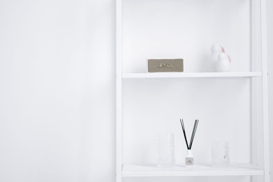 A minimalist white shelf styled with a few decorative objects